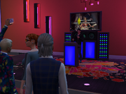Sims singing karaoke.