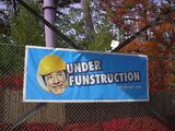 Under FUNstruction sign with the Asian man