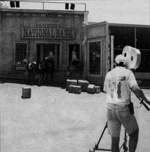 A cameraman "filming" a bank robbery scene for the Bonnie and Clyde streetmosphere experience