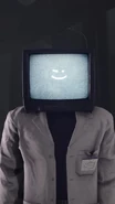 The Scientist TV Man displaying an emoticon on his TV screen, unlike the full-screen version.
