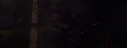 An Obliterator Astro Toilet barely visible in the trees, cornering the POV-Cameraman, and his squad.