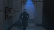 A scanner scanning Detective Cameraman as he walks towards the door.