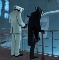 Scientist Cameraman 1337 and Plungerman looking at Titan Cameraman getting repaired.