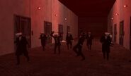 The squad are walking through the hallway with some of them are danving.