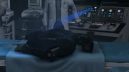 A blue scanner scanning Plungerman's dead body.