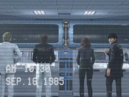 Состоит в научной группе C, слева от Кэти в чёрной рубашке