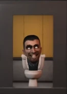 El primer Skibidi Toilet.png (111 kB) Un Skibidi Toilet Normal con la cabeza anormalmente grande dentro de un ascensor