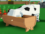 A cow eating from a wooden trough