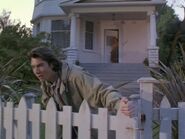 Quinn tests the garden gate after returning from his first visit to an alternate Earth.