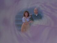 A view of a double of Quinn's mother and the gardener through the vortex as Quinn leaves the first world he visits.