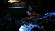 Lois is holding Chloe's body in the water.