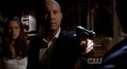 Lex pulls a gun on Kal.