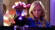 "Kara" trying to steal the orb from Lex's safe.