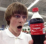 Logan holding a Coca-Cola bottle with his name on it.