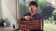 Ian carving wood that looks like a bread box.