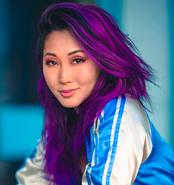 Mari in 2019, with purple hair.