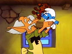 The Toymaker is pleased to see that Baby Smurf has found a toy that he wants to play with.