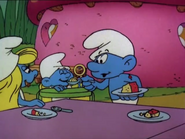 Baby Smurf tries his very first piece of Smurfberry Honey Cake in "The Last Smurfberry".