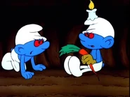 Miner Smurf (right) has a candle on top of his hat.