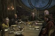 Count Olaf having dinner with his troupe.