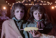Violet and Klaus, as freaks, awkwardly eat corn.