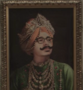 Barry in the Hotel Denouement Indian restaurant. (It's the same painting seen at Uncle Monty's house.)