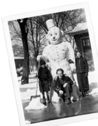 Three actors by the snowman.