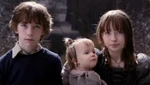 Violet and Klaus with Violet holding Sunny.