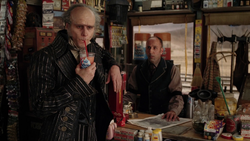 The clerk watching Olaf drink a soda/slurpee.