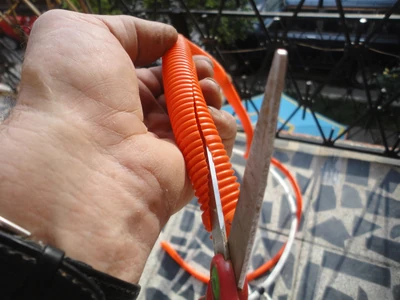 Cut the tubing in a long diagonal with scissors.
