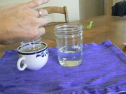 The bottle is immersed in bubble solution