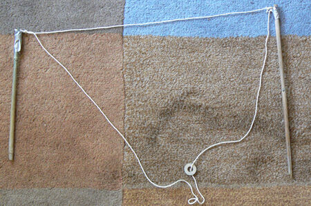 A primitive tri-string wand