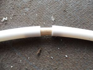 The hoop is spliced together at the very top of the hoop opposite the bridge