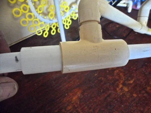 The left side of the T (to the left of the bridge) has a longer sleeve piece as shown. For smaller diameter hoops 1/2" "T" pieces work well and the shims are not necessary