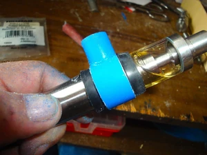 Slide on the bottom CPVC piece and the second rubber washer--make sure the washers are snug against the CPVC piece. IMPORTANT: The surfaces of the CPVC piece that contact the rubber washers have to be very smooth and clean to make a good seal.