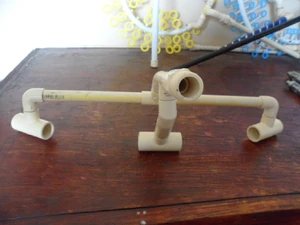 Further example of the assembly of the bridge design. Note that the bottom 3 CPVC "T" pieces are 3/4" with a reduced 1/2" center port used only for the 35" diamter hoop using 1/2" PEX tubing. For the smaller 25" diameter hoop 1/2 "T" pieces are adequate.  IMPORTANT:  The angles for the bottom 3 "T"'s need to be correct suited to the size hoop you are making.  It is best to mock up the final design of the entire hoop before you make any permanent attachments