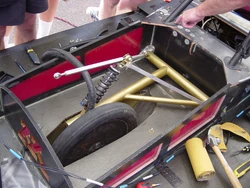 UMNSVP Borealis2 RS Fail 1.jpg (129 KB) This picture gives and overview of the suspension layout. The link hanging to the left over the shock is supposed to attach to the five grommets being pointed at.