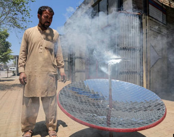 Kabul blacksmith, Ghulam Abbas, demonstrates the power of his hand-built parabolic solar cooker