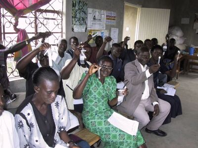 Workshop participants with Colilert tubes to test home water in Nyakach Kenya