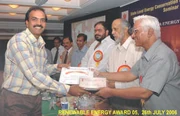 Professor Ajay Chandak accepts a renewable energy award from Mr