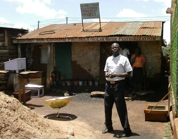 Camily Wedende in front of his workshop in October 2013