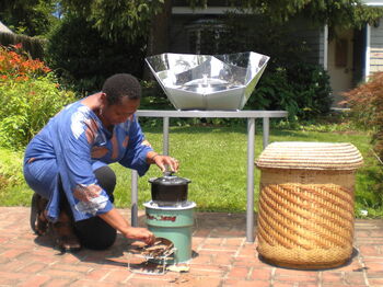 This solar kitchen comes with a pot and a solar-cooking device