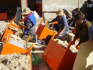 Participants in a workshop put on by  pack wool into their  to act as insulation.