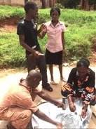 Faustine explains solar cooking to employees_of_Awamu_Biomass_Energy_Ltd.- Bernhard Mueller