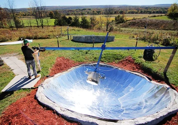 Bjorn Qorn uses a large in-the-ground solar cooker to produce their product for sale.