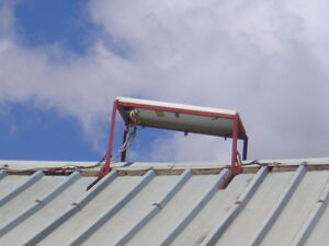 Solar panel on modest house in village in Kenya.
