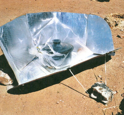 Rocks are used to anchor this CooKit solar cooker so that it is not blown over by the wind at the Iridimi refugee camp in Chad.