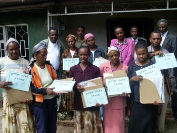 Participants hold their folded  solar panel cookers.