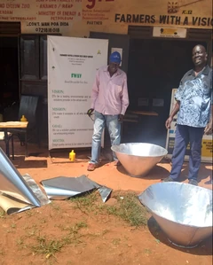 Didacus Pius Odhiambo (right) with Frankey Henno at Farmers With A Vision finishing construction of the Funnel solar cookers