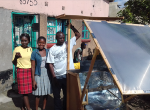 Clement Mosonda with the Heliac solar cooker, 5-8-18